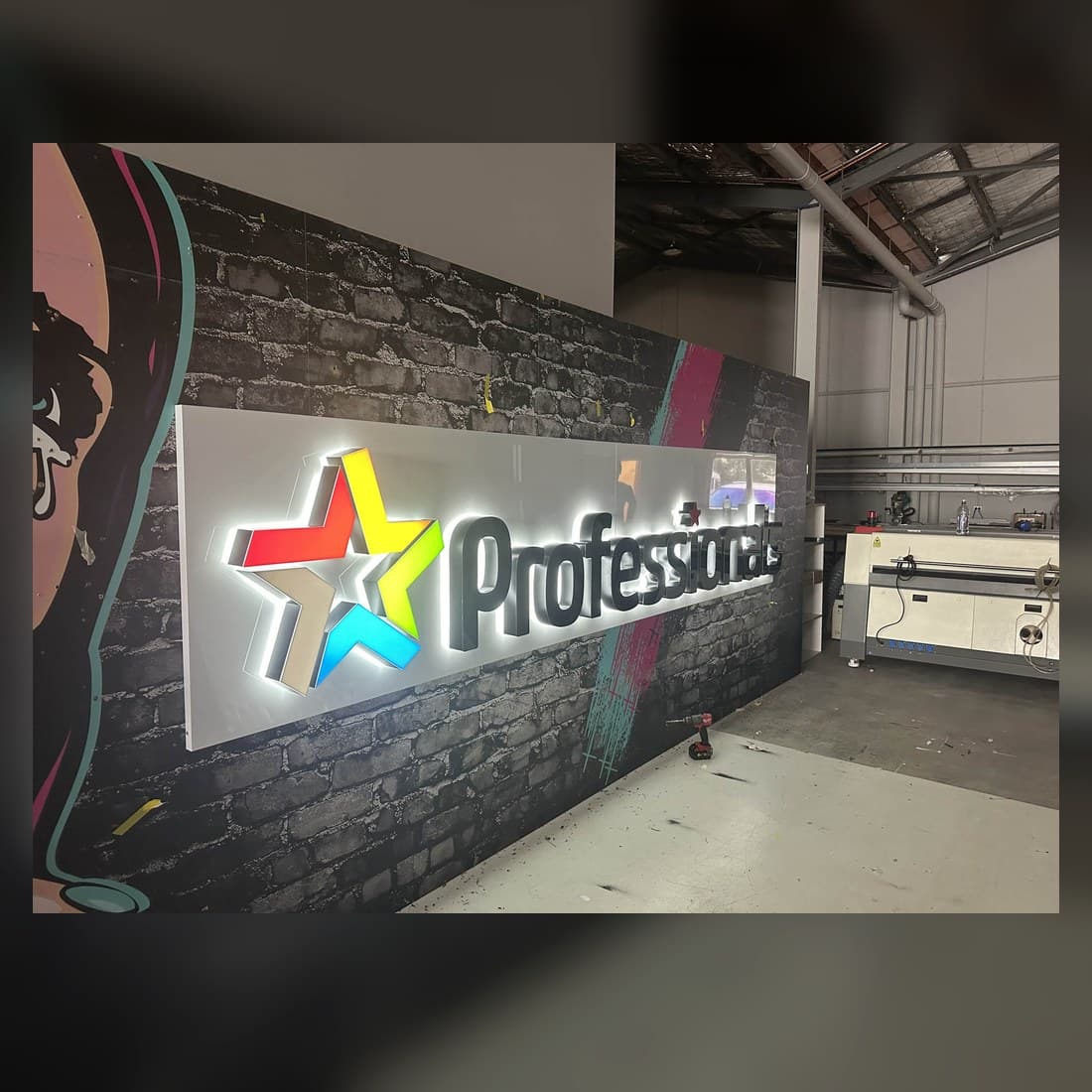 Real dimensional illuminated Protek sign mounted in a workshop